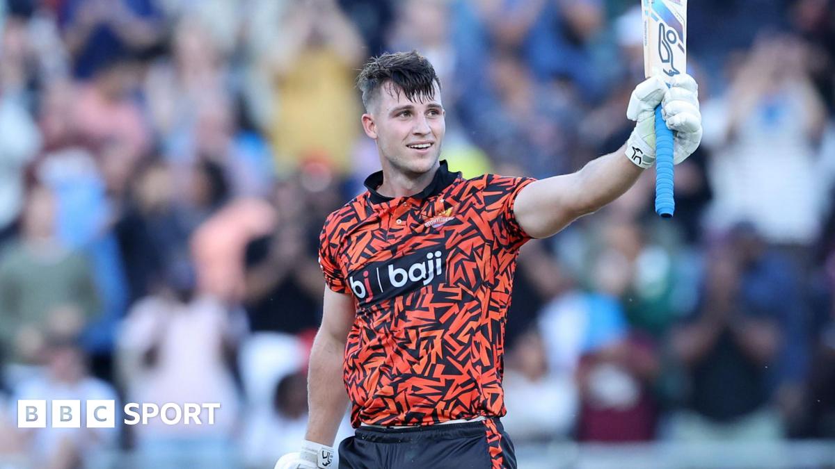 Jordan Hermann holding his bat in the air while standing on the pitch during a match for Surisers Eastern Cape