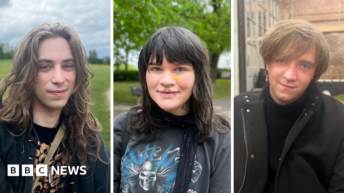 Three young people look directly into the camera lens and pose for a photograph. The photos have been taken separately and have been framed together. Fergus, on the left, has long wavy hair and is sitting in an open green space. Lucian, in the middle, is sat in a park with a leafy tree in the background. They have long hair and a fringe, are wearing two yellow star patches on their cheek and have a nose ring and two lip piercings. Matthew, on the right, is slightly tilting his head while posing indoors with a foosball table and a brick wall in the background. The pictures are separated by two slim white margins.