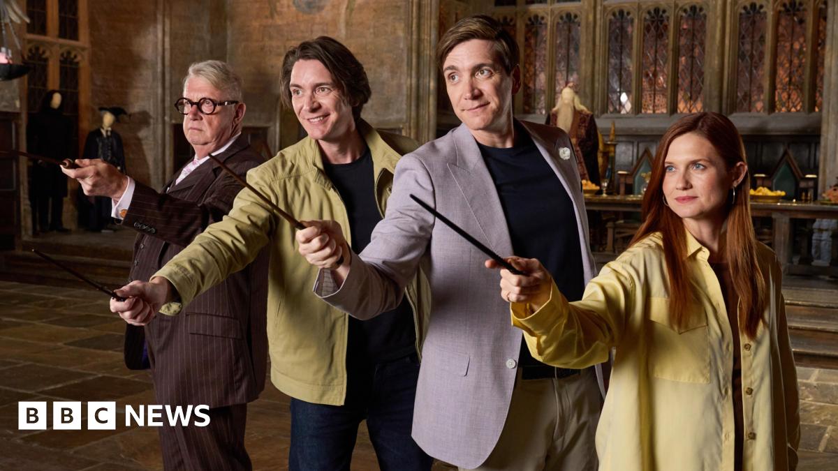 Four actors recreating a scene from Harry Potter as they each hold a small sword in front of them as they stand in a line next to each other. There are three men wearing jackets and one woman who is wearing a large yellow shirt.