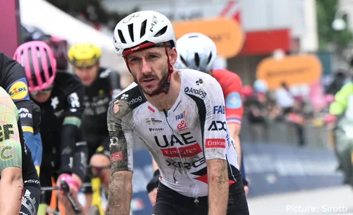 A bloody and muddy Adam Yates crosses the line after crashing on stage 2 of the 2026 Giro d'Italia