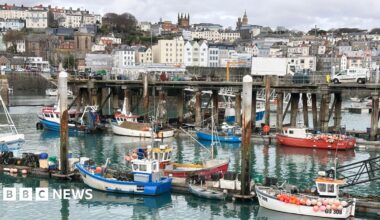 Small boats on the harbour with buildings in the background