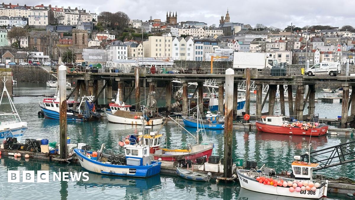 Small boats on the harbour with buildings in the background