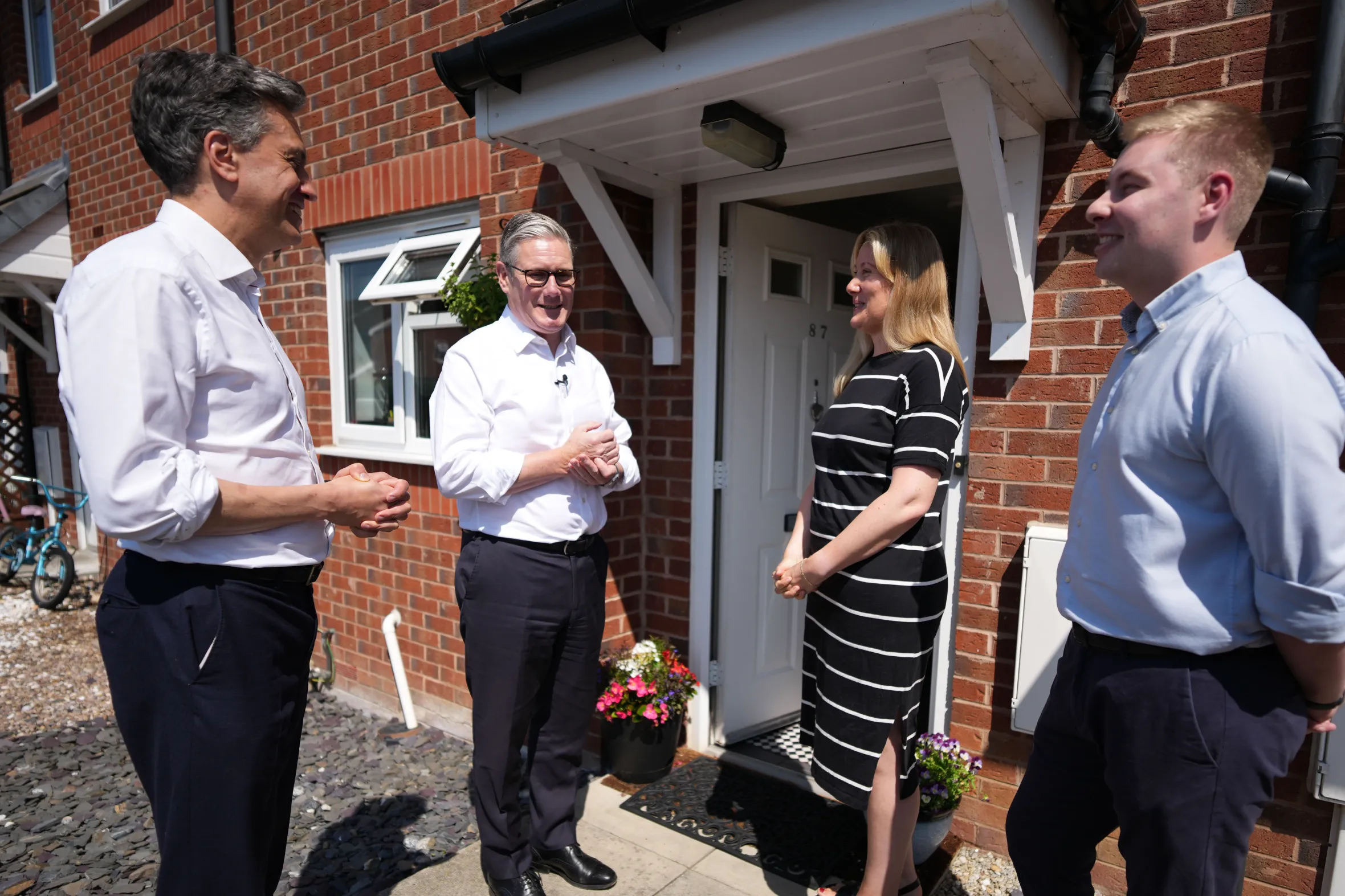 Secretary of State for Energy and Climate Change Ed Miliband, Prime Minister Keir Starmer, and Jacob Collier, MP for Burton and Uttoxeter, meeting with Universal Credit claimant Nicola Saint at her home.
