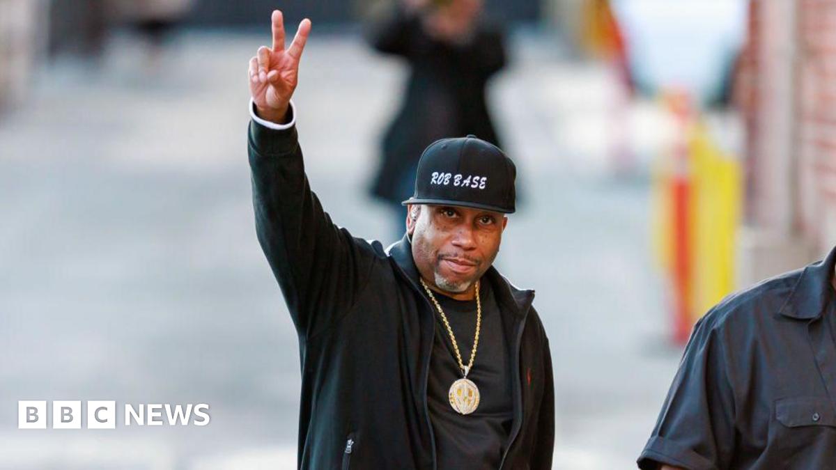 Rob Base photographed on the streets of New York throwing up the peace sign