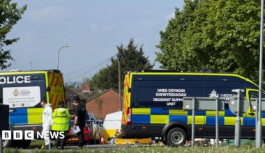 Emergency services staff and vehicles on Aberthaw Road.