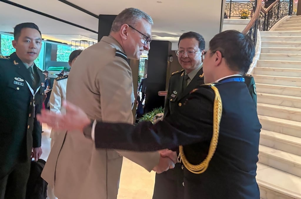 Major General Meng Xiangqing (centre) meets Britain’s Air Commodore Dom Stamp on Friday. Photo: Amber Wang