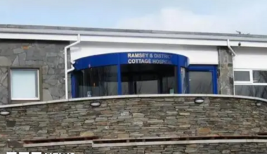 The front entrance to the hospital, which has a blue revolving door.