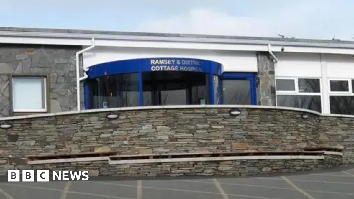 The front entrance to the hospital, which has a blue revolving door.