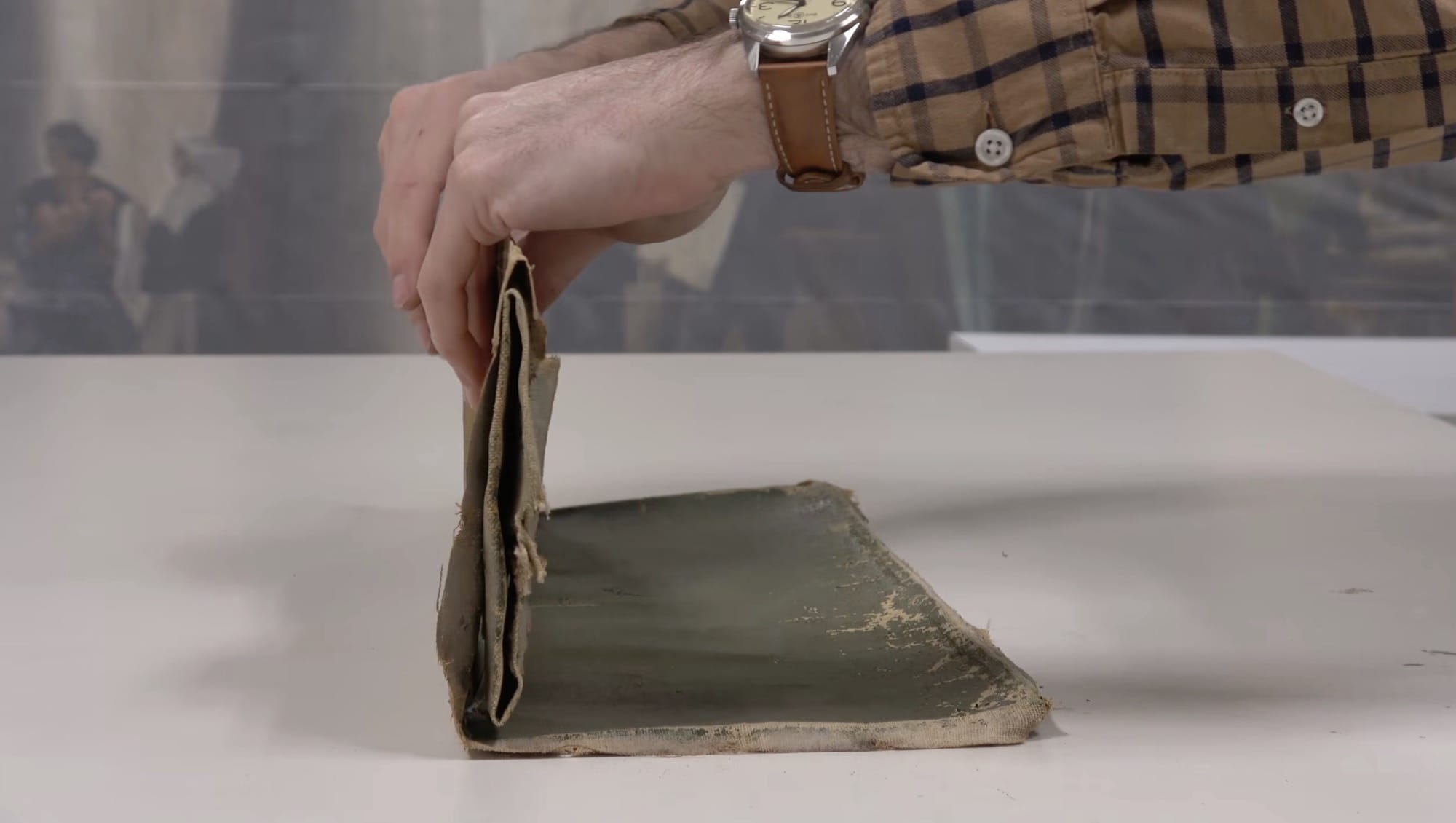 a still from a video by Baumgartner Restoration of a painting being unfolded