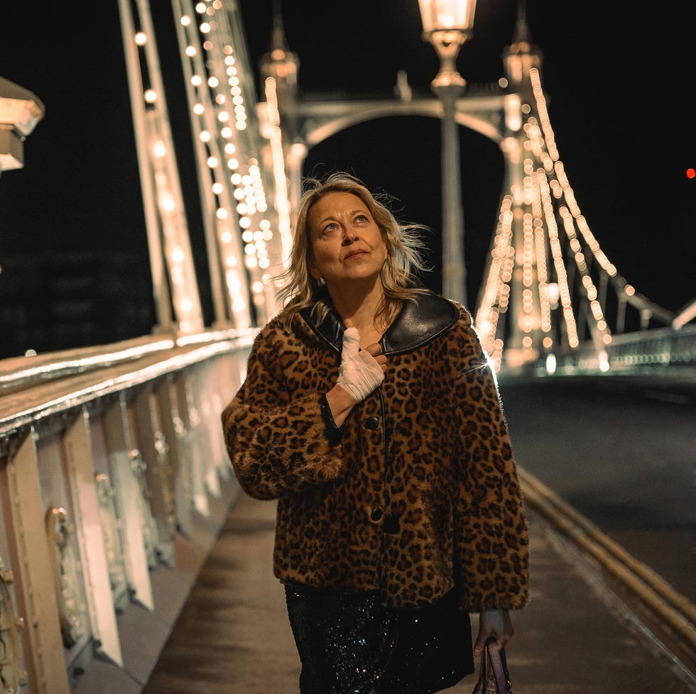 Individual walking on a bridge at night Individual walking on a bridge at night