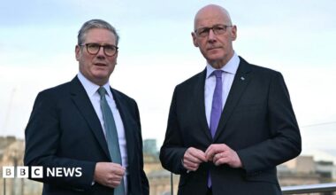 Sir Keir Starmer and John Swinney. Sir Keir has grey hair and Swinney has a bald head. They are both wearing glasses and dark suits with white shirts. Sir Keir is wearing a blue tie and Swinney a purple tie.