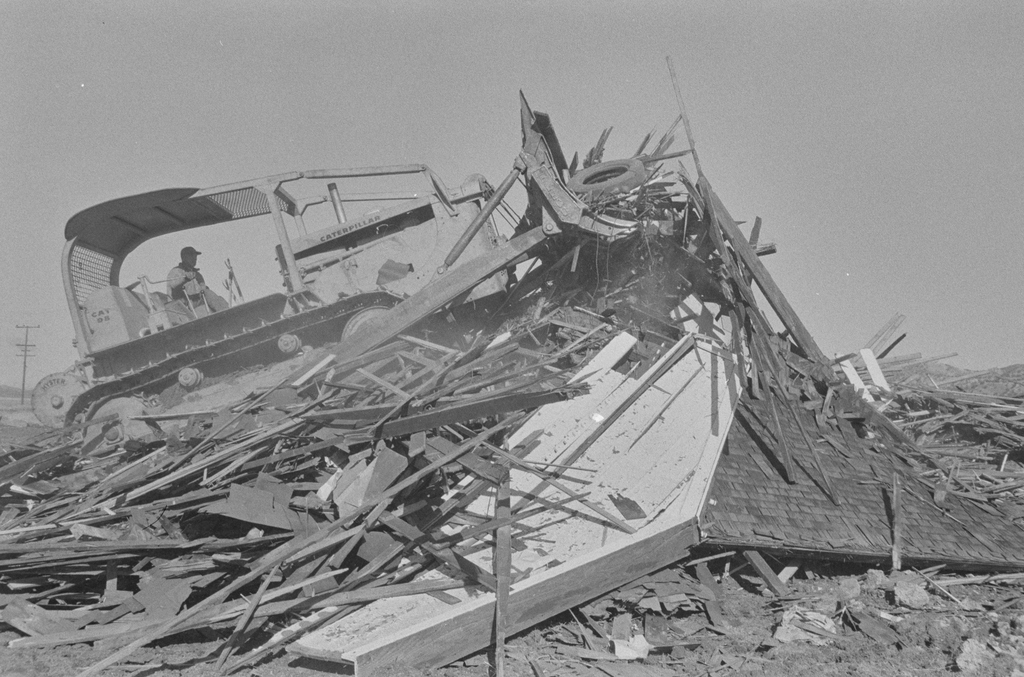 Demolition of Cook, McKenzie and Son Store with bulldozer