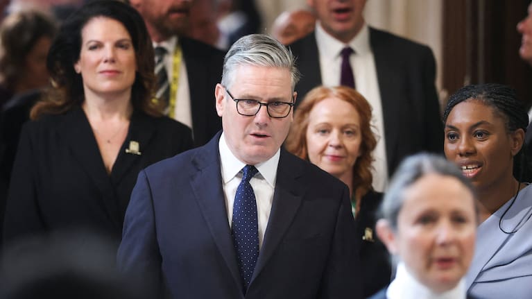 British Prime Minister Keir Starmer, center, walks through the House of Commons to attend the State Opening of Parliament at the Palace of Westminster, London.