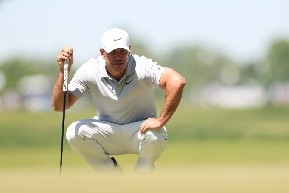 Brooks Koepka of the United States looks over a putt on the third hole during the third round of the PGA Championship at Aronimink Golf Club on May 16, 2026