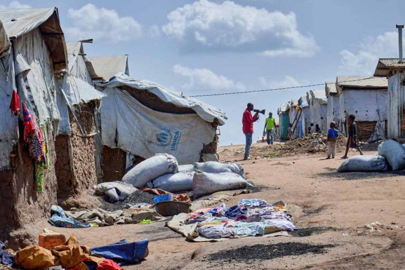 Richard Mbagaro, a supervisor at the Kigonze camp for internally displaced people, speaks through a megaphone, urging residents to wash their hands with soap or ash as fear grows over the spread of Ebola, in Bunia, Democratic Republic of Congo, on May 25, 2026. (Photo: Reuters)