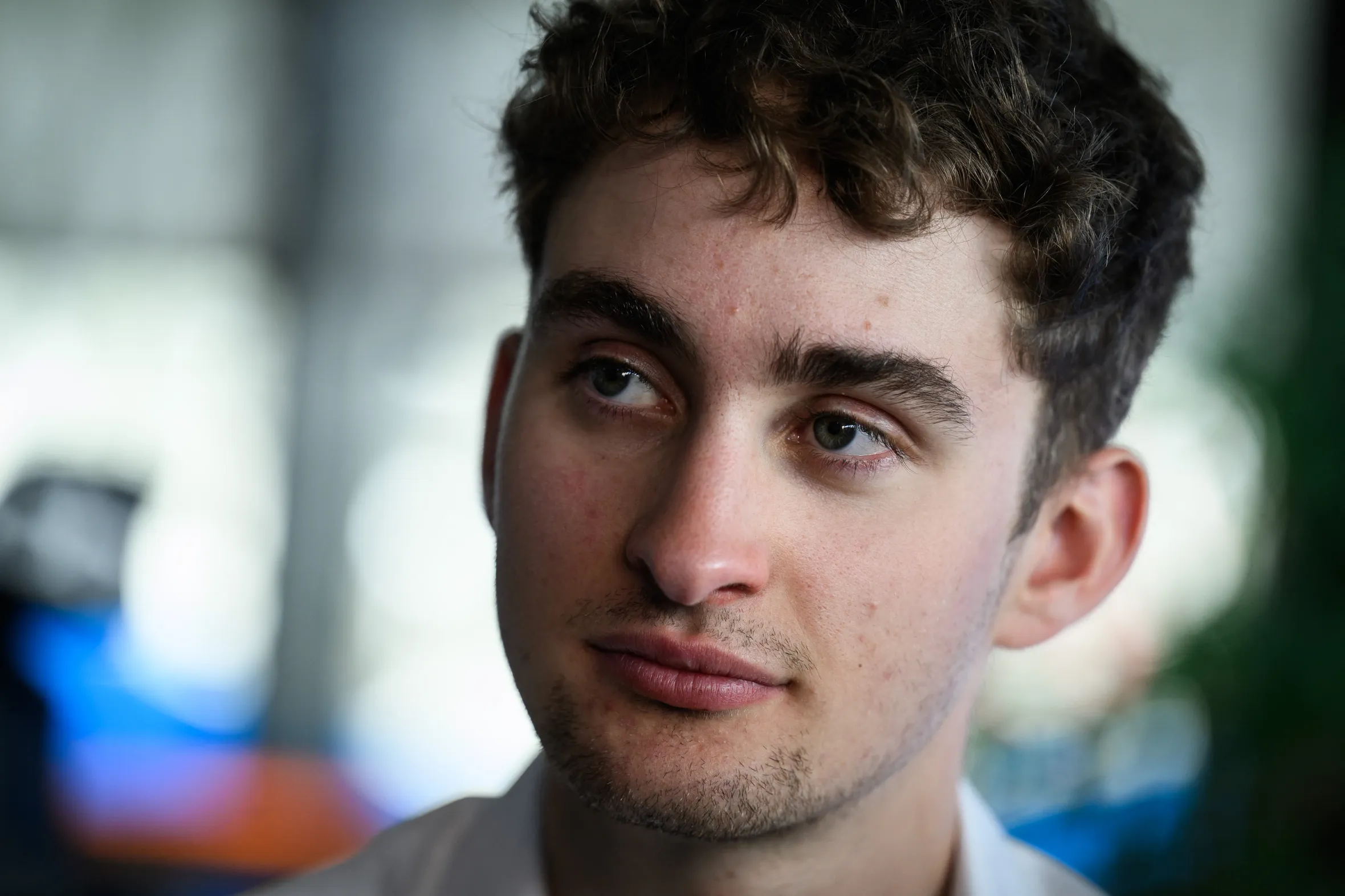French rider Paul Seixas looking slightly to his right during a press conference.