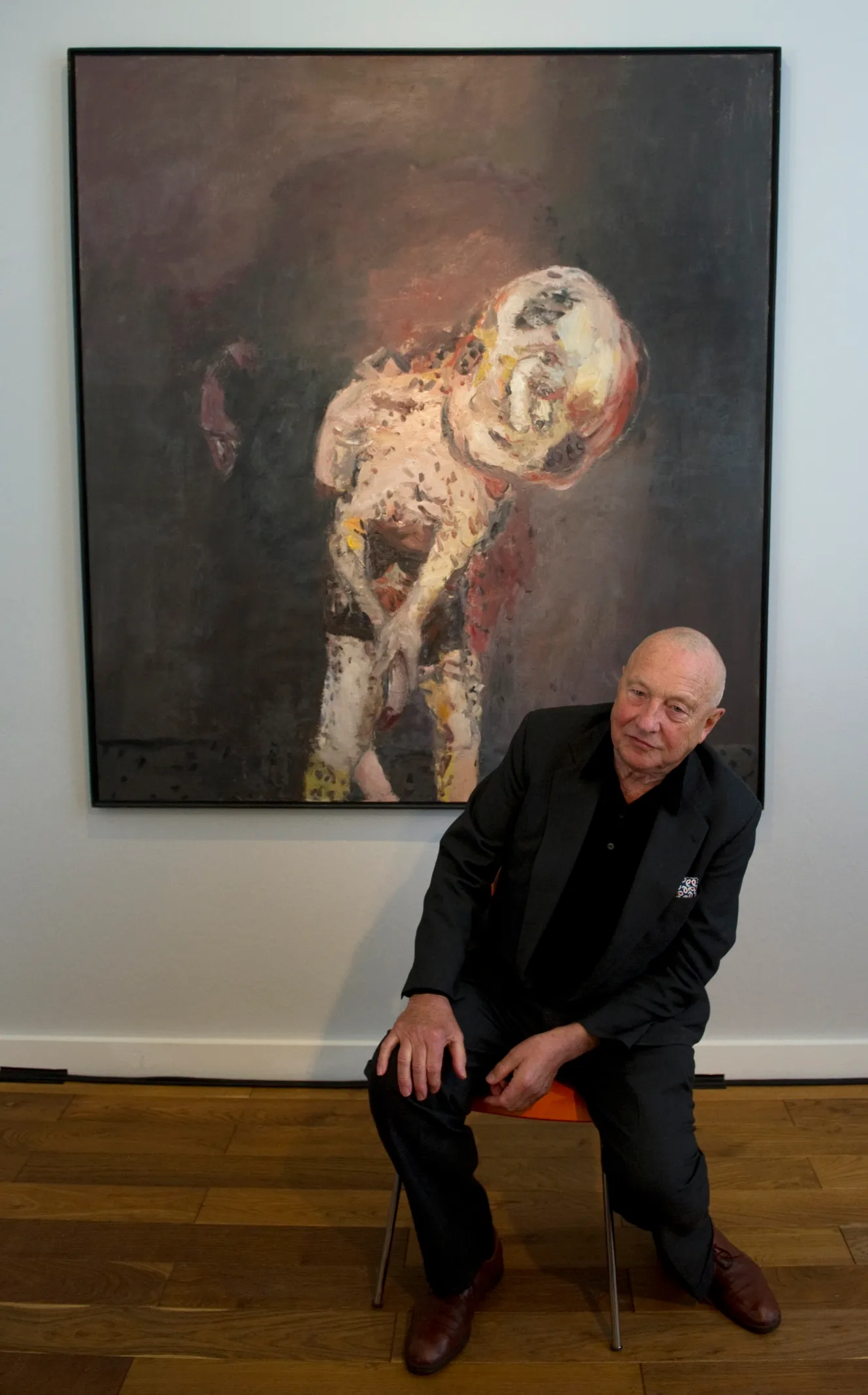 German painter Georg Baselitz addresses a press conference, sitting in front of his painting "Grosse Nacht im Eimer" (Big Night Down the Drain - 1962-1963).