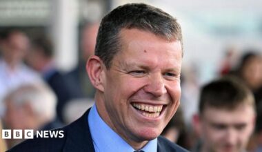 A smiling Rhun ap Iorwerth on the steps of the Senedd building