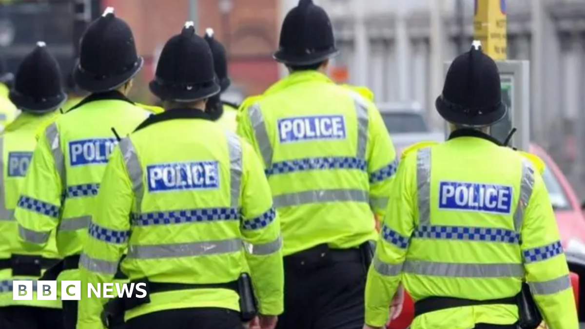 A crowd of police officers wearing high vis jackets and hats