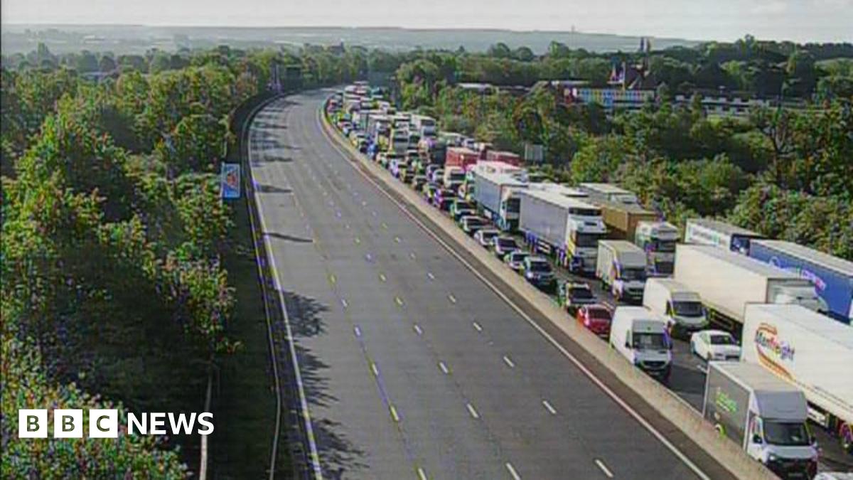 An overhead view of a motorway, where one side is heavily congested with traffic.