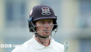 Cameron Bancroft with his navy blue Gloucesteshire helmet on and his bat under his left arm