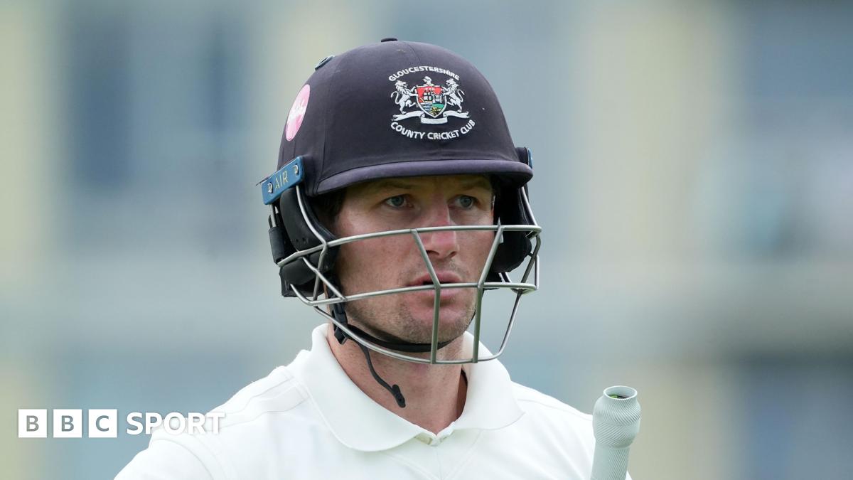 Cameron Bancroft with his navy blue Gloucesteshire helmet on and his bat under his left arm