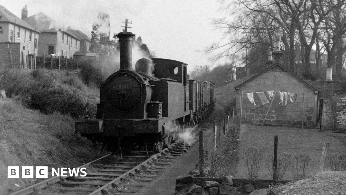 A black and white image showing a daily goods train on the Monkland & Kirkintilloch line travelling between Whitegates and Woodilee, 7 March 1960.