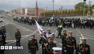 A marching band parades through the streets of Moscow