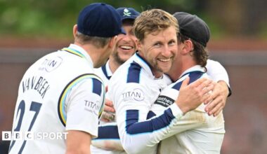Joe Root is hugged by his team-mates after taking a wicket for Yorkshire against Somerset