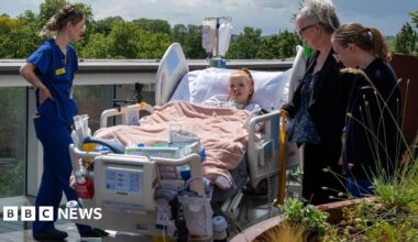 Hollie, 29, a patient at King's College Hospital, is wheeled onto the new rooftop intensive care unit in south London in her hospital bed, surrounded by three nurses dressed in blue uniforms.