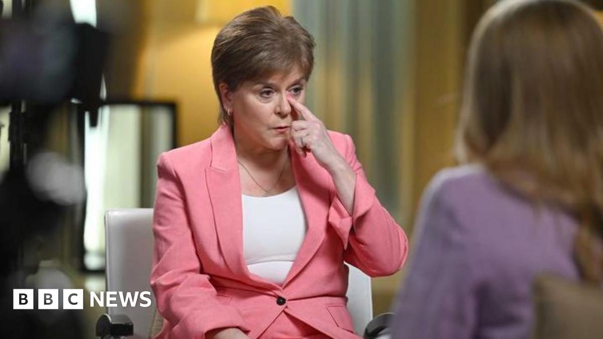 Nicola Sturgeon speaks to Laura Kuenssberg, who is out of shot. Sturgeon is wearing a white top and pink suit