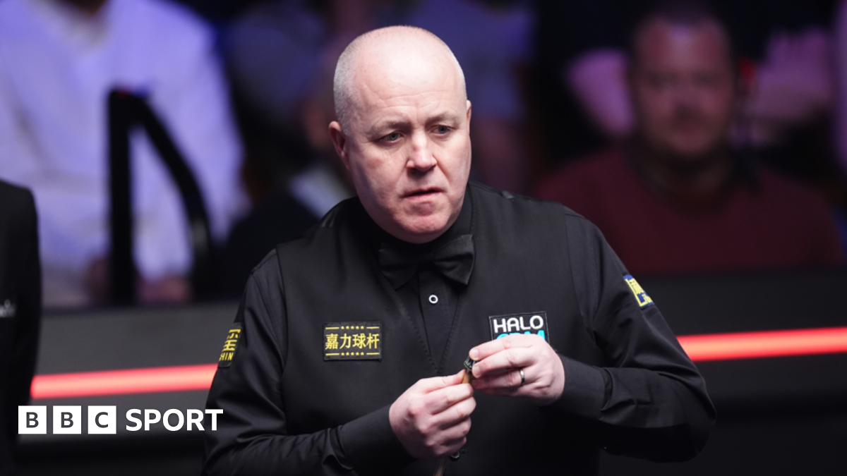 John Higgins lines up a shot