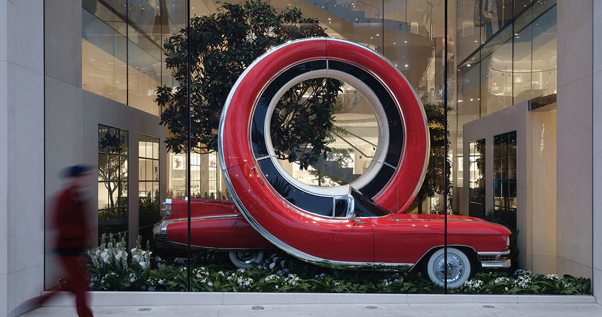 alex chinneck twists NYC taxis and LA cars into storefront sculptures for dior