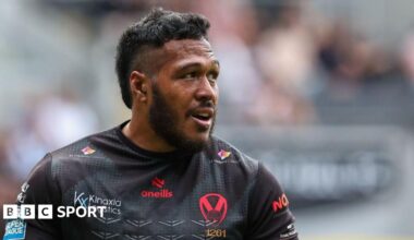 Agnatius Paasi is wearing a black St Helens top and is looking to his left.
