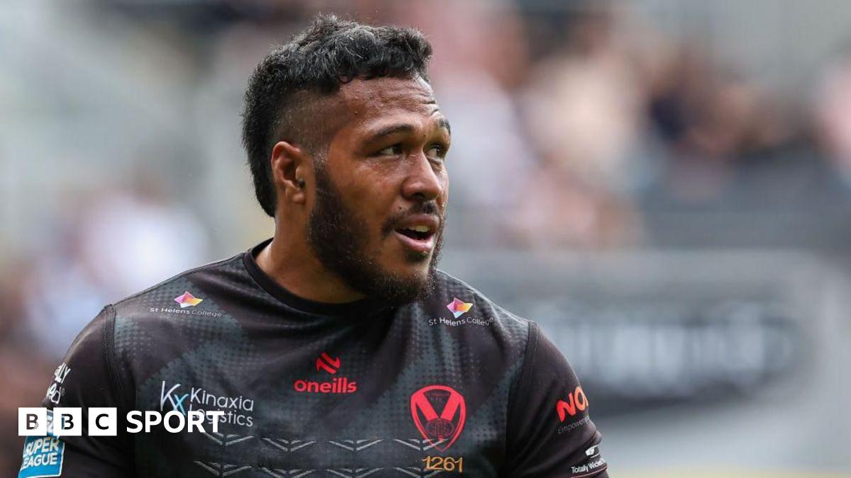 Agnatius Paasi is wearing a black St Helens top and is looking to his left.