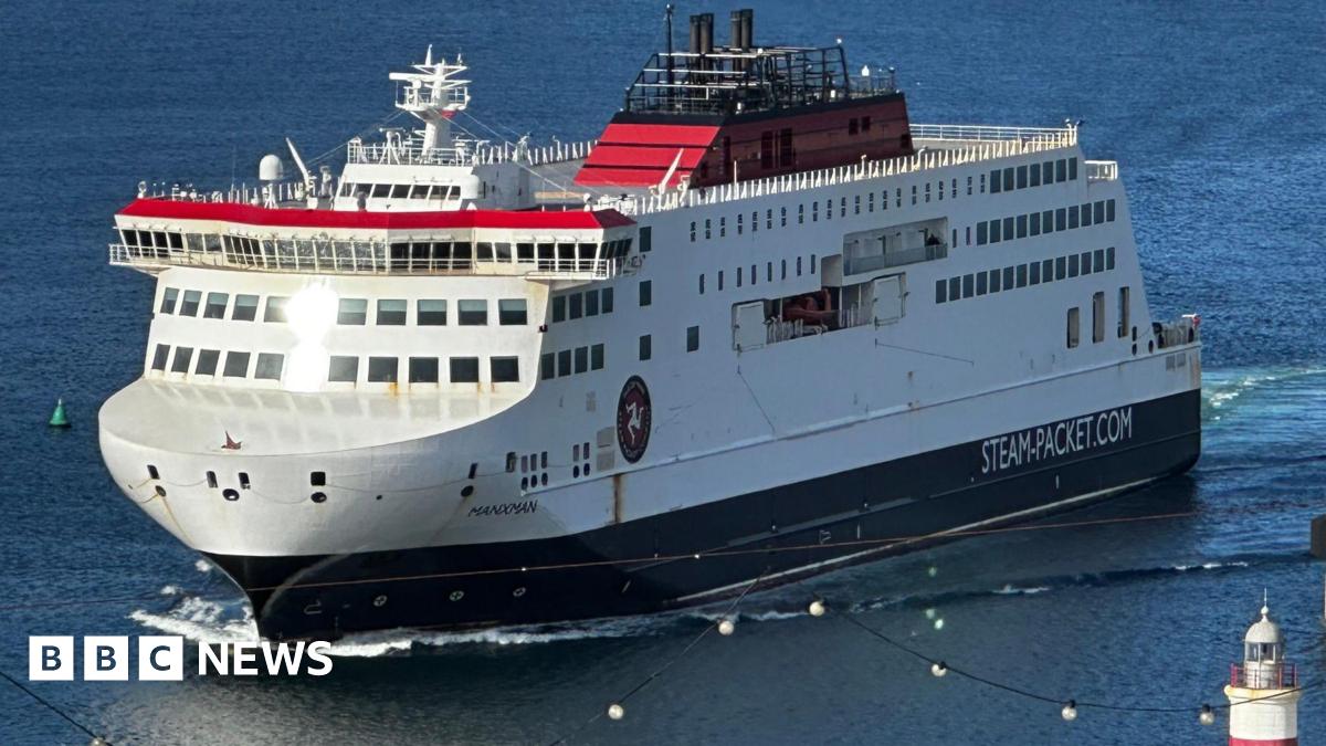The Manxman ferry, which is white, red and black and has Steam-Packet.com on the side, entering Douglas Harbour.