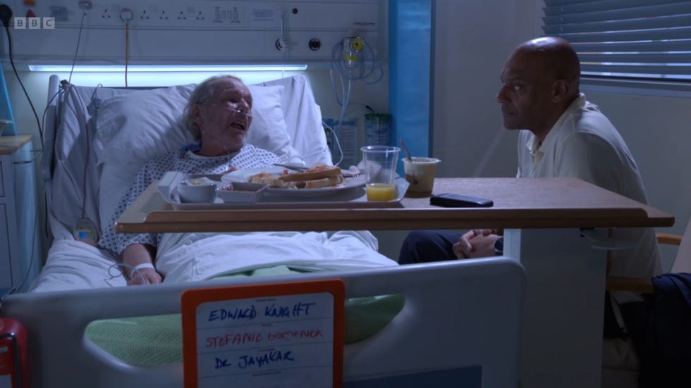 eastenders eddie and george knight in a hospital room, with george by eddie's bed