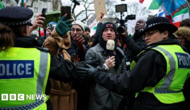 Activist Stephen Yaxley-Lennon, known as Tommy Robinson, wears a Unite the Kingdom beanie at a protest