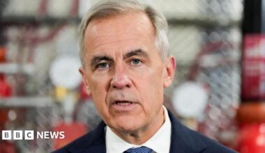 A close-up image of Mark Carney mid-speech. He has short grey and black hair and grey eyes.