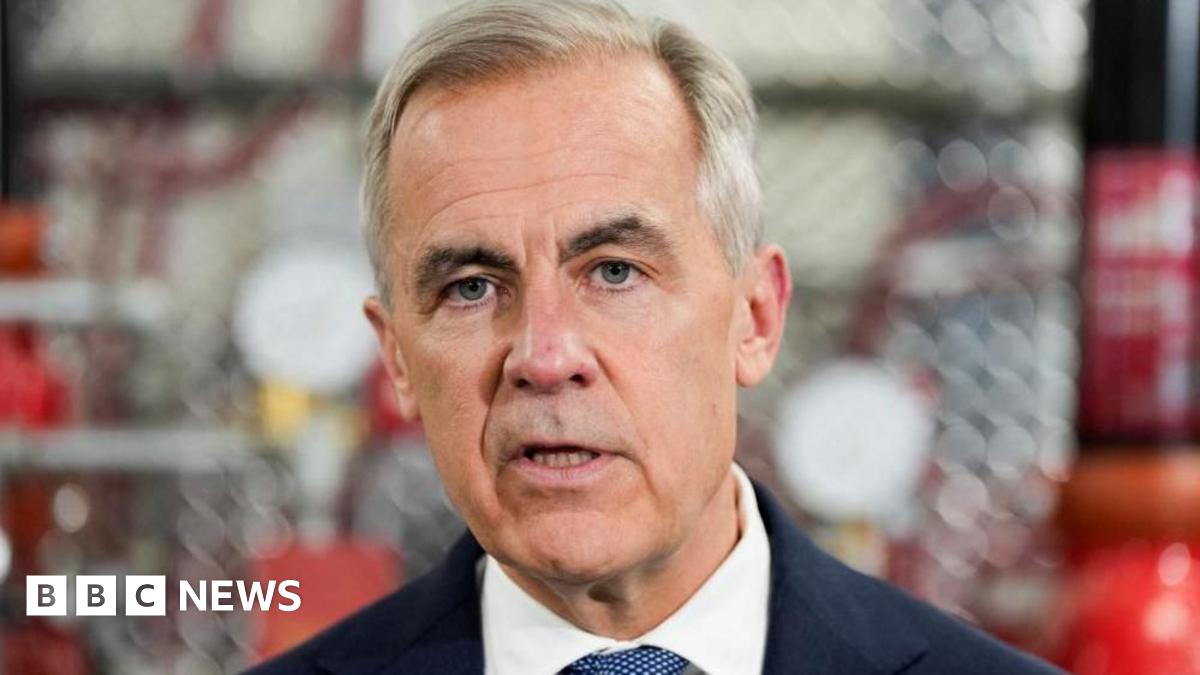 A close-up image of Mark Carney mid-speech. He has short grey and black hair and grey eyes.