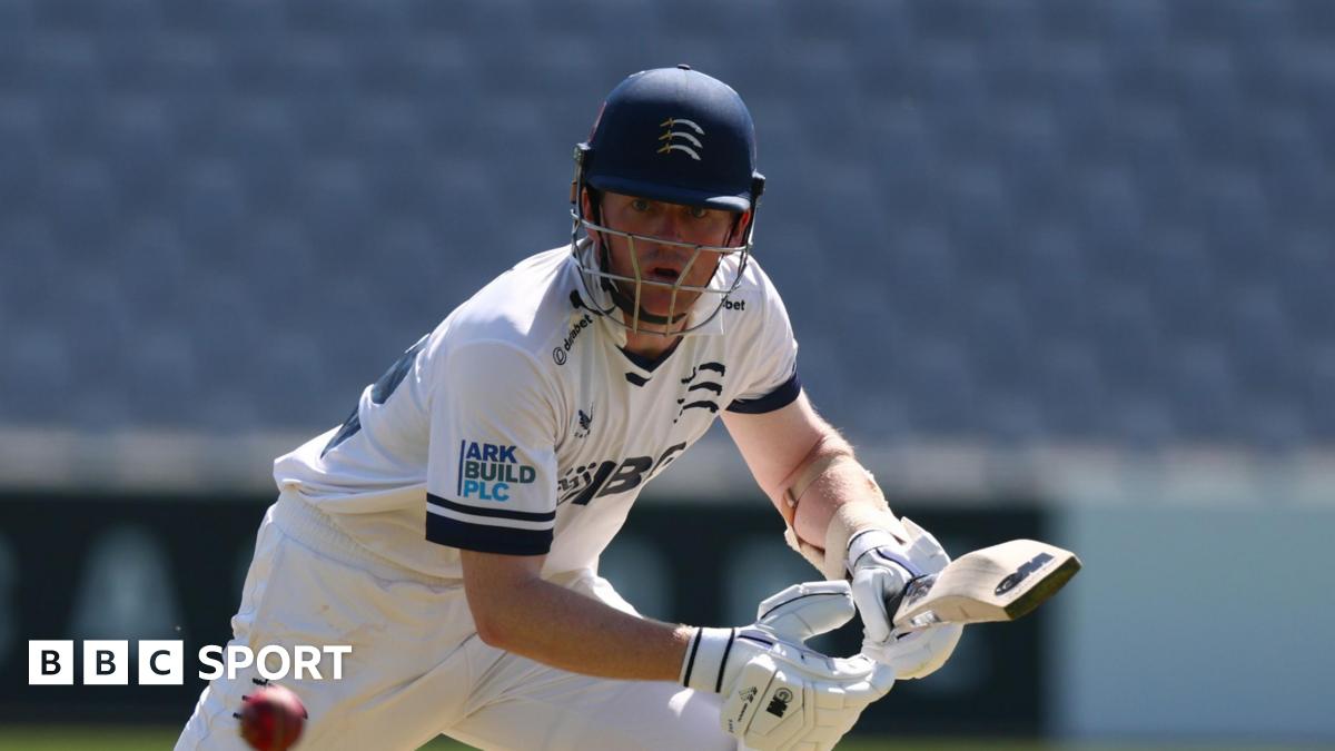 Sam Robson watches carefully as he steers a ball into the offside while batting at a sunny Lord's