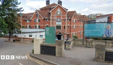 The entrance to the Spire Hospital is pictured from the road. Redbrick hospital buildings are seen in the background