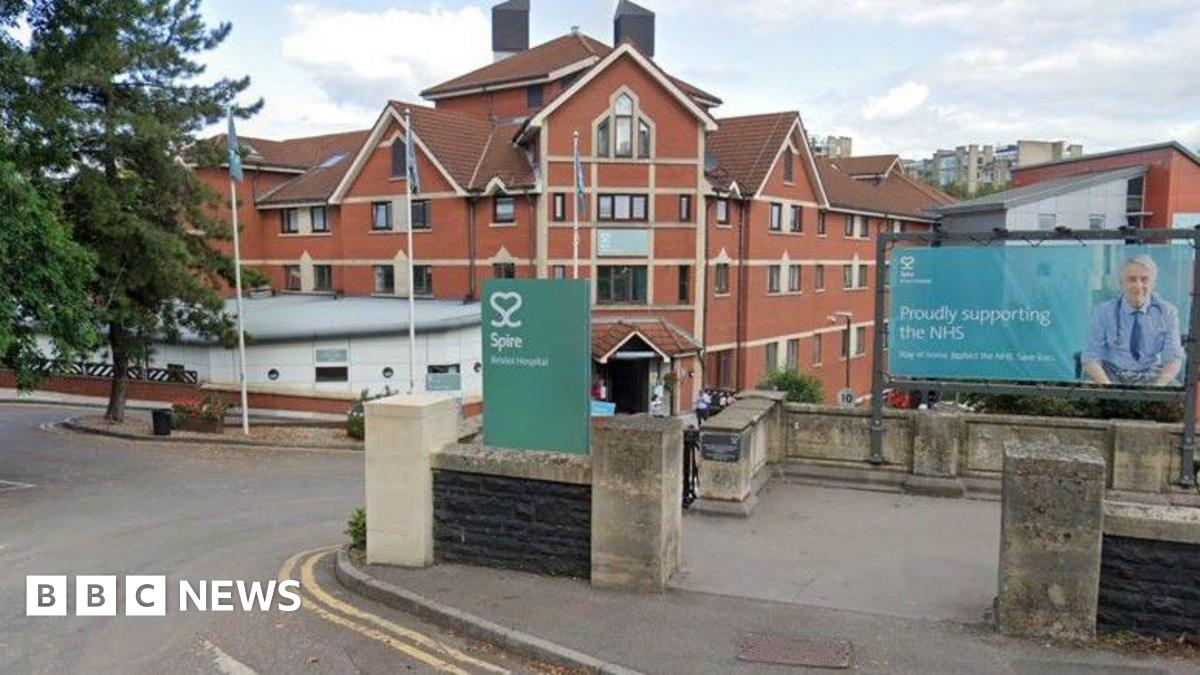 The entrance to the Spire Hospital is pictured from the road. Redbrick hospital buildings are seen in the background