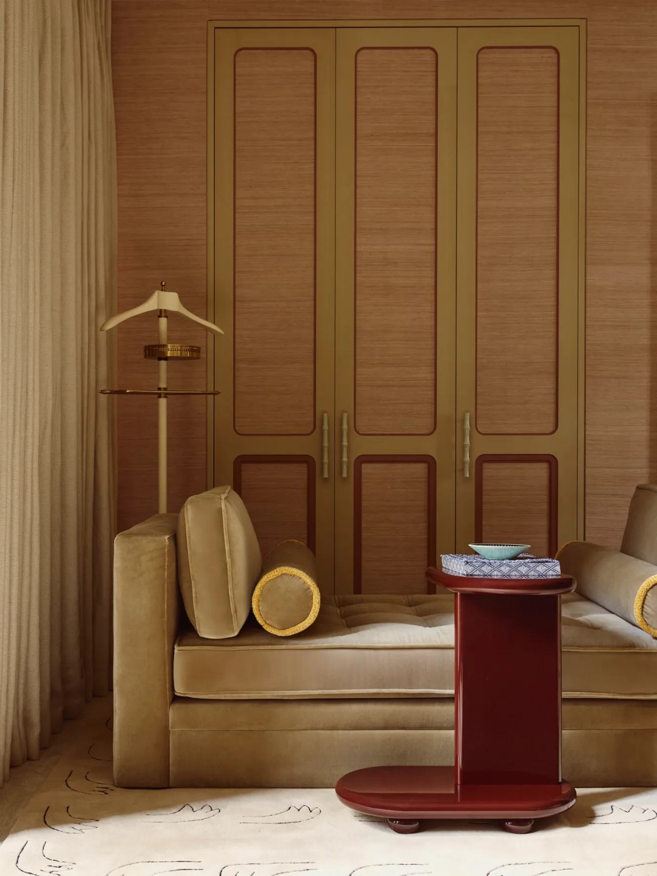 A tranquil dressing room featuring a custom daybed, red lacquered sidetable, and Iris wall fabric.