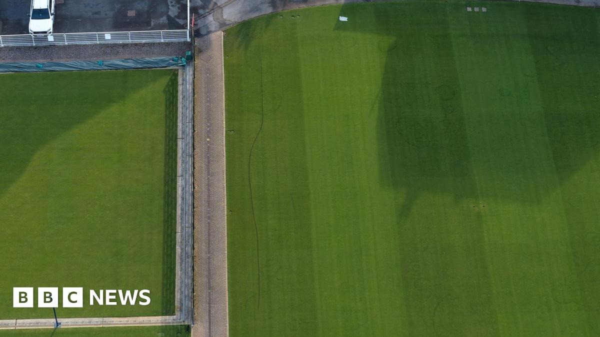 A deep line running across a tennis lawn.