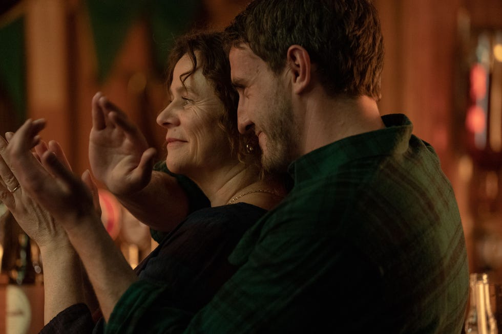 emily watson and paul mescal close together and looking happy and clapping in god's creatures