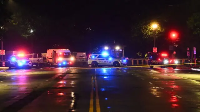 Police vehicles and tape blocks off a crime scene near the White House after a gunman opened fire in Washington DC.