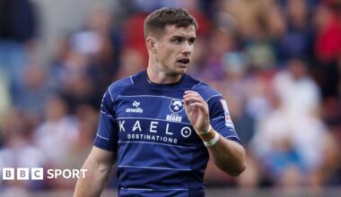 Bristol Bears rugby player AJ MacGinty wearing a dark blue rugby shirt during a Premiership match with Leicester Tigers.