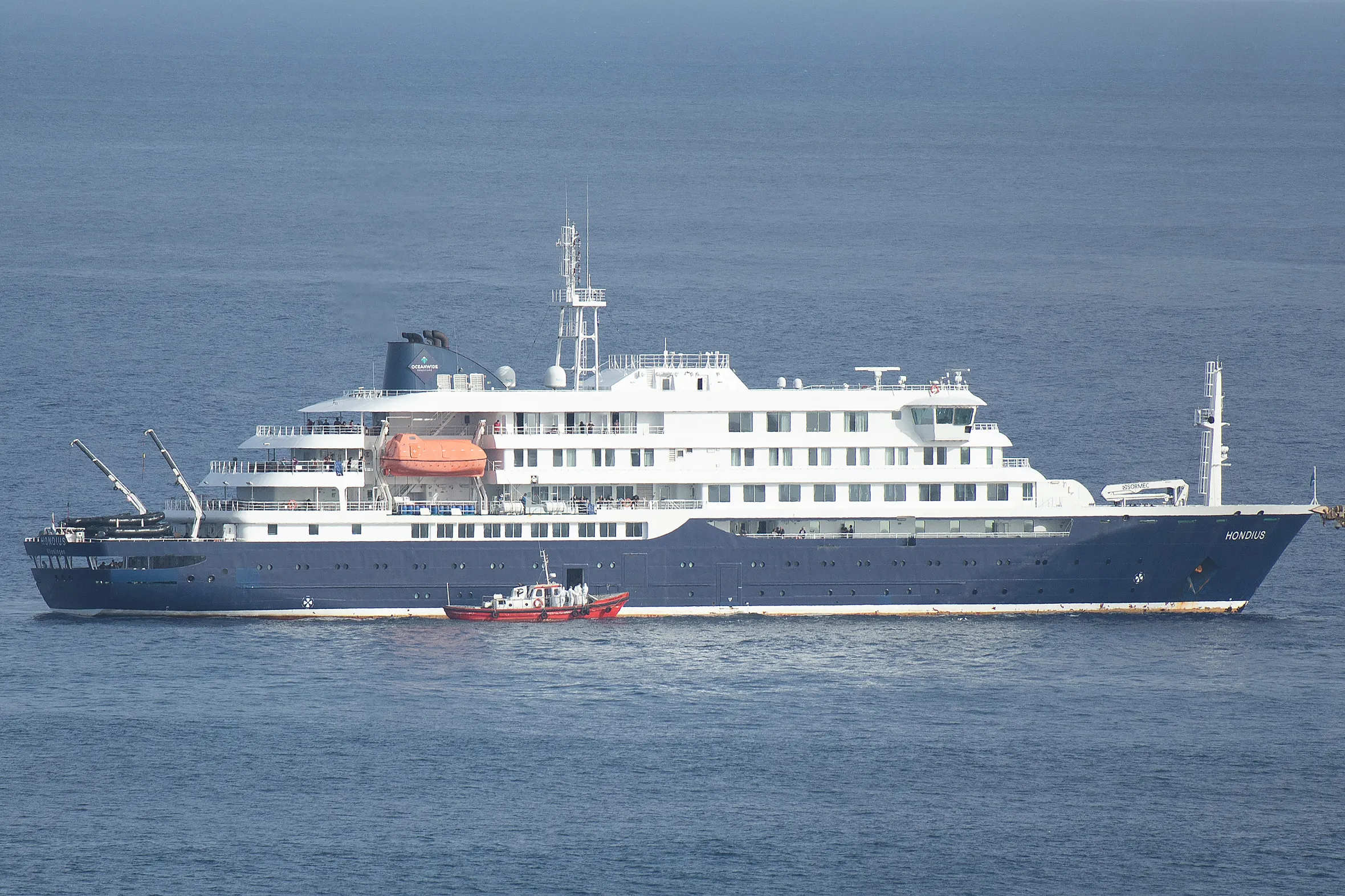 An ambulance boat with crew in hazmat suits approaches the cruise ship MV Hondius off the coast of Cape Verde.