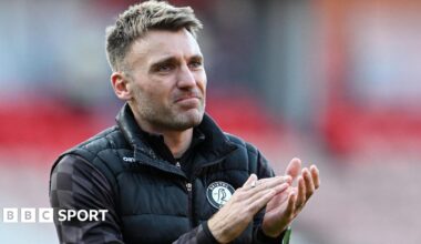 Chris Manning applauds fans during his time as Bristol City assistant head coach